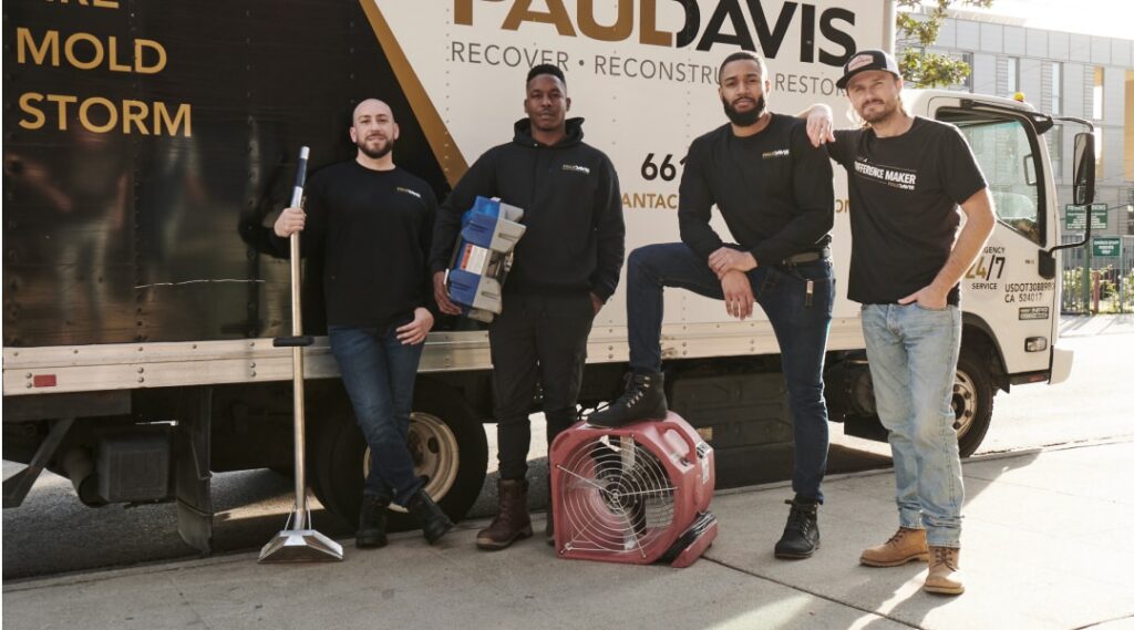 Paul Davis Restoration team with equipment and service truck providing water, fire, and mold restoration services in Brooklyn West.